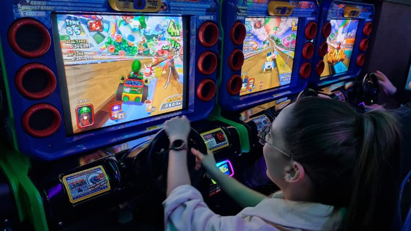 Girl plays Mario Kart at Planet Royale arcade, Perth