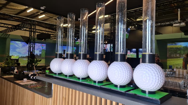 Image of 6 beer towers with the base shaped like golf balls