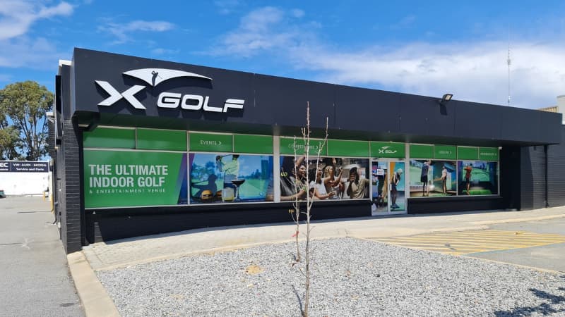 Image of the front of the X-Golf Balcatta building. It's black with white logo on the upper left corner