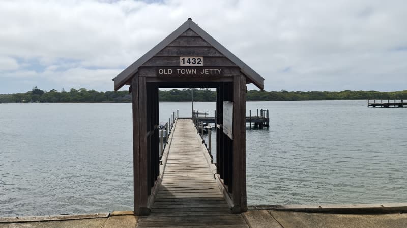 Image of Ellis Street Jetty. There is a shelter that says "Old Town Jetty" and the jetty extends out behind it into the water.