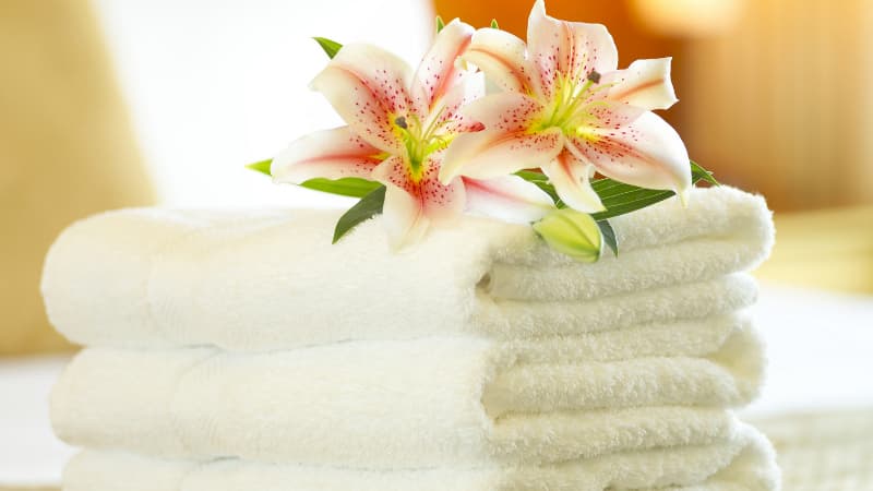 Towels for sauna with two flowers on top
