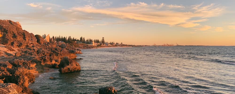 Image of a rocky beach. Cottesloe beach is visible in the background