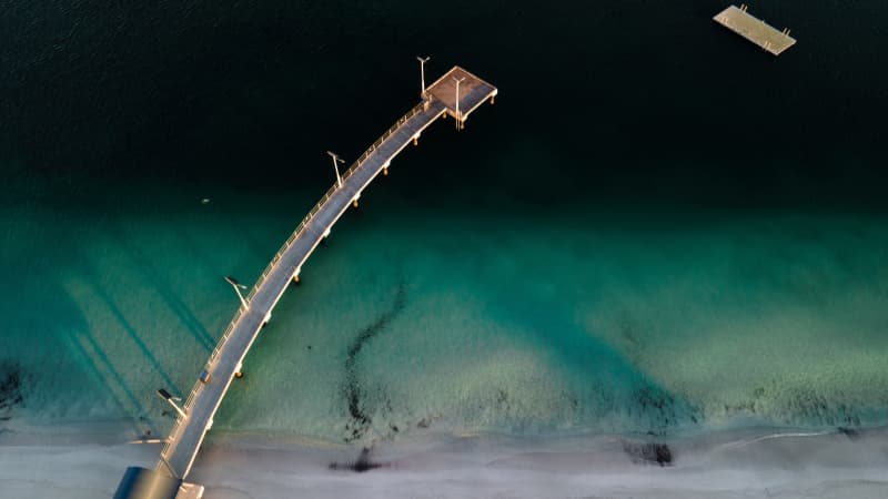 Jurien bay jetty reaching out to the dark water as seen from above