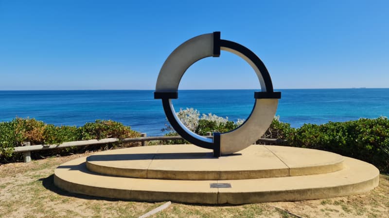 Circular sculpture at Cottesloe with the ocean in the background