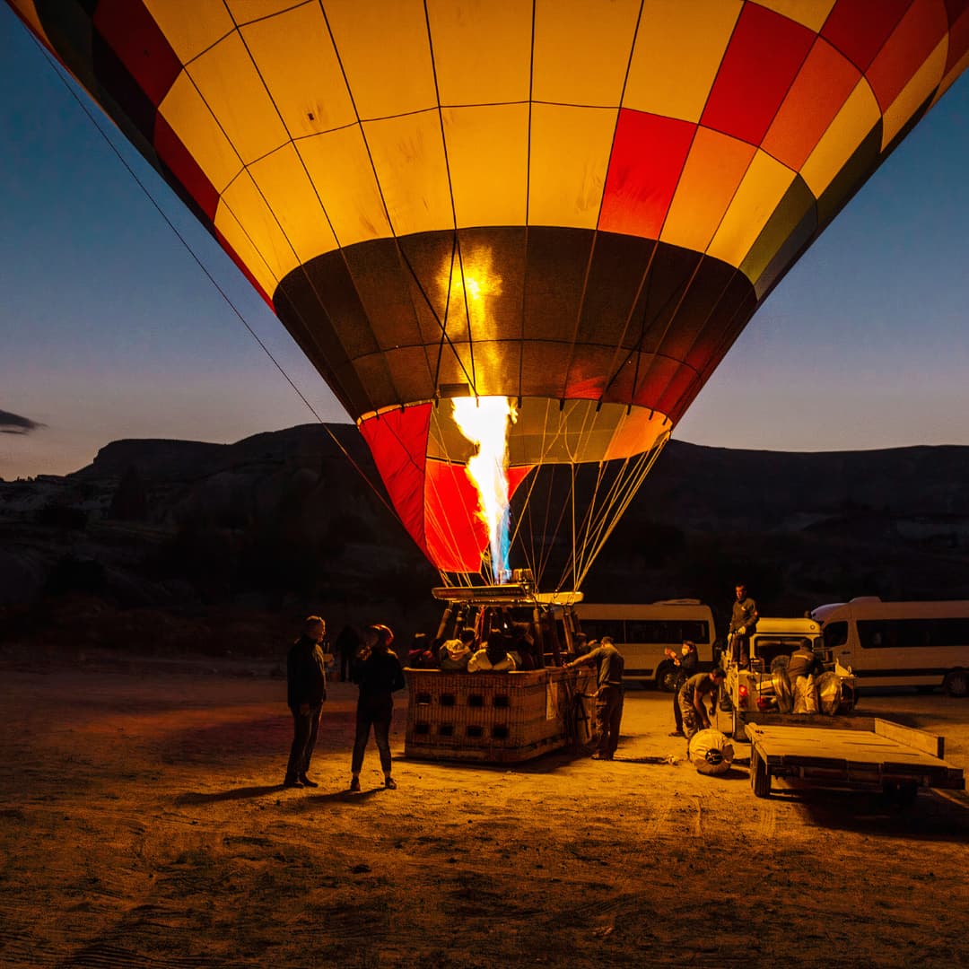 A hot air balloon is launched just before sunrise