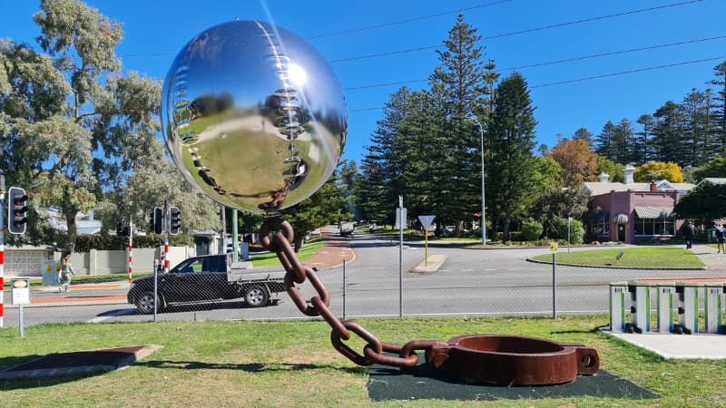 Silver ball on a chain sculpture called Lucky Country
