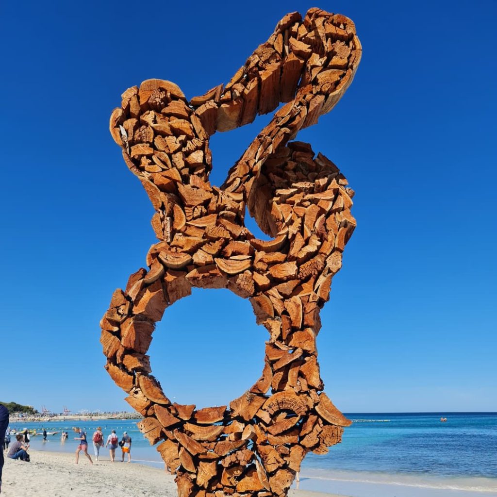Abstract curving sculpture made from logs of wood