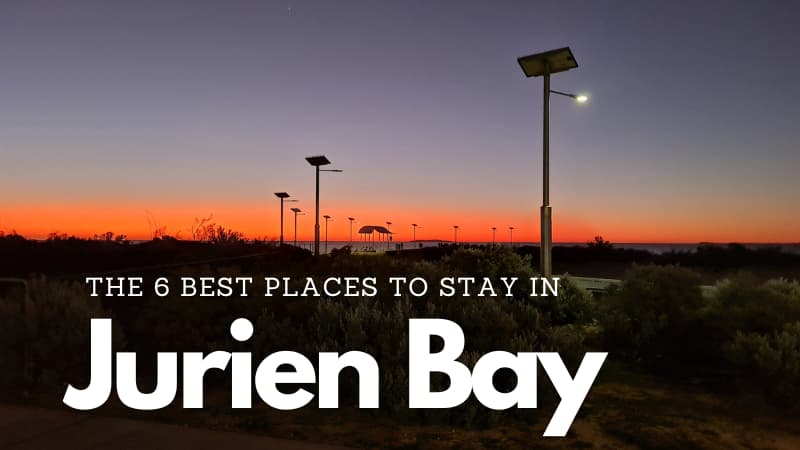 Jurien Bay Jetty at sunset. The sky is a purple to pink gradient. The overlaid text reads "The 6 best places to stay in Jurien Bay"