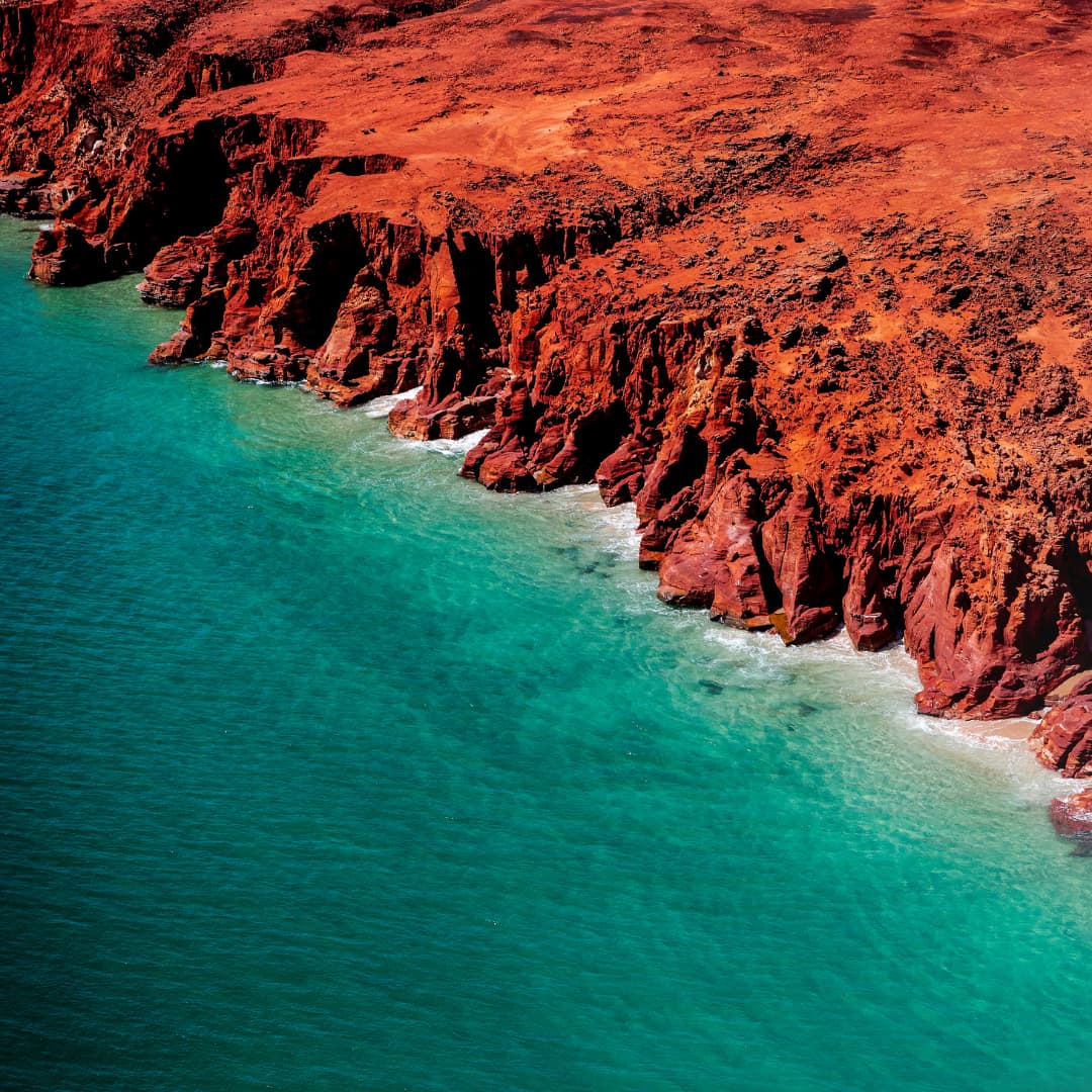 Red cliffs of the Kimberley meet the turquoise ocean