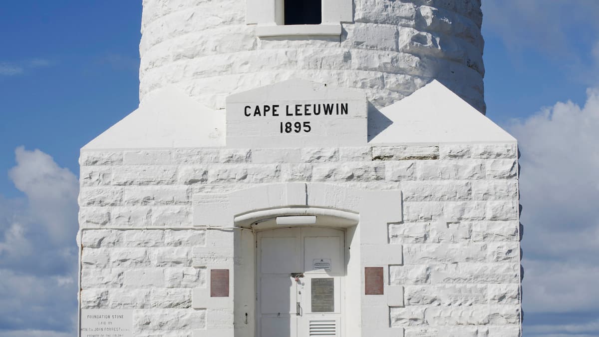 The entrance to Leeuwin Lighthouse stands bright and white against the blue sky