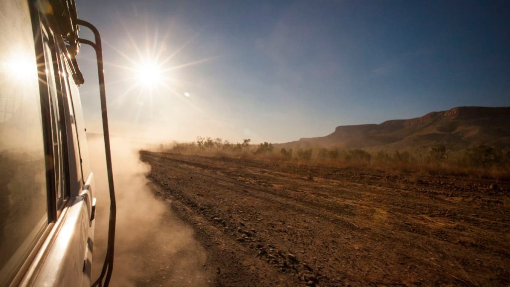 Best 4wd tracks perth View from a 4WD driving along a dusty outback track under the hot afternoon sun