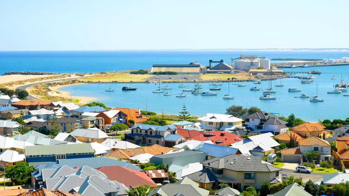 Elevated view of Bunbury Harbour with boats, waterfront homes and the Indian Ocean in Bunbury, Western Australia.